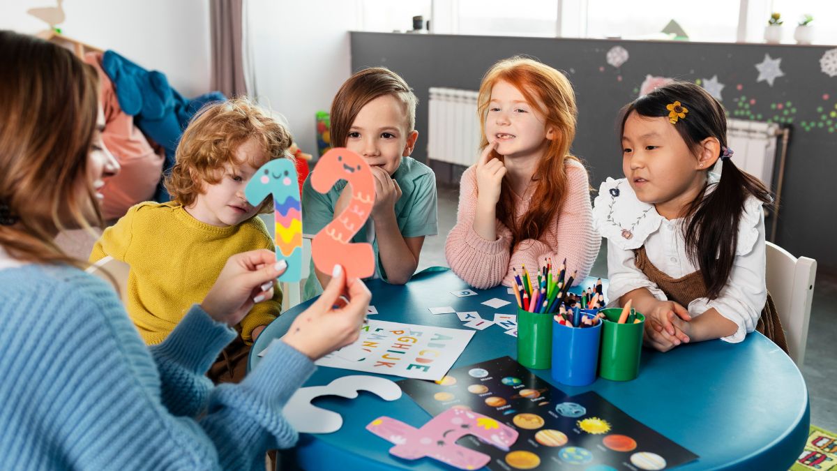 Activities for autism classroom, a female teacher leads an activity while children listen intently.
