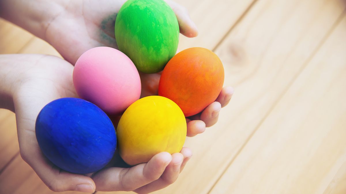 Sensory items autism, hands hold soft multicolored egg-shaped sensory toys for tactile play and focus.